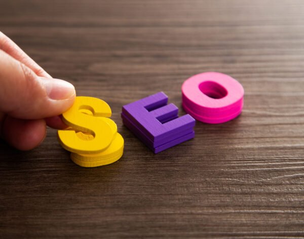 Hand arrange wood letters as SEO abbreviation Search Engine Optimization