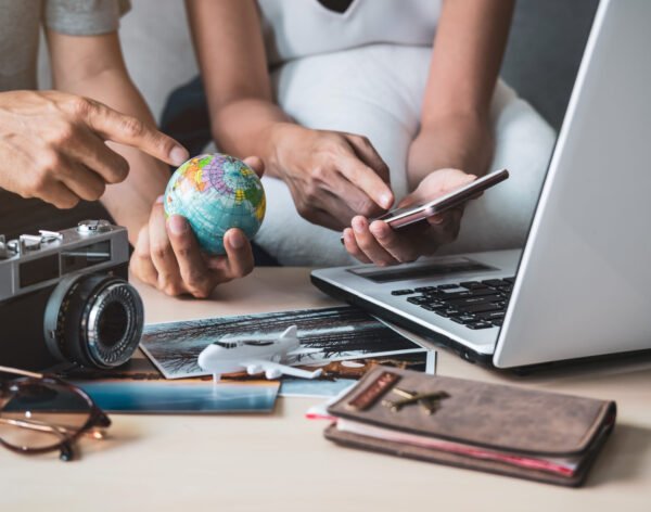 Young couple planning vacation trip and searching information or booking hotel on a smart phone