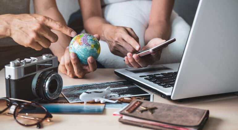 Young couple planning vacation trip and searching information or booking hotel on a smart phone