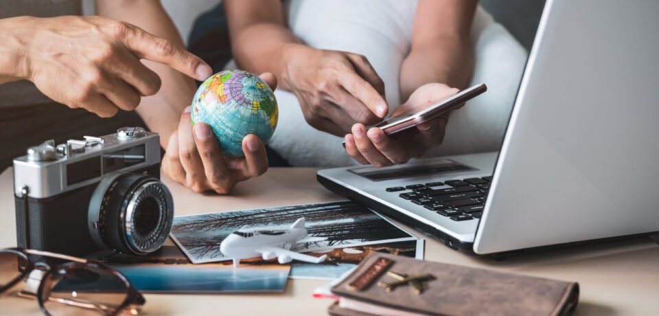 Young couple planning vacation trip and searching information or booking hotel on a smart phone